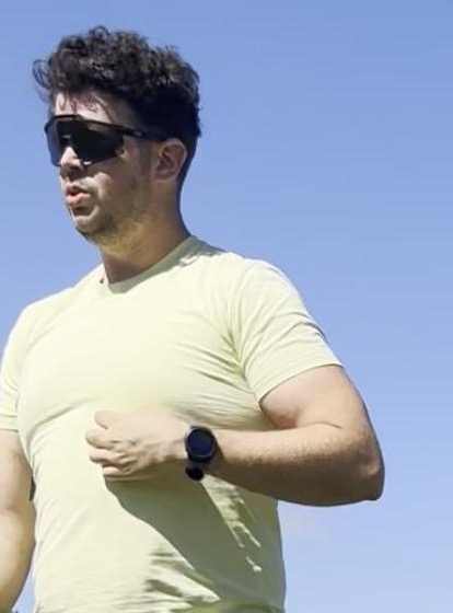 Rory running on a grass field in summer